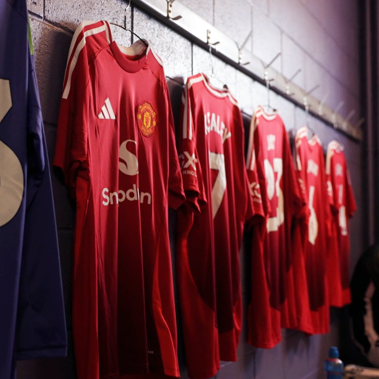 Video screenshot of Manchester Uniter jersey's hanging in the changing room.