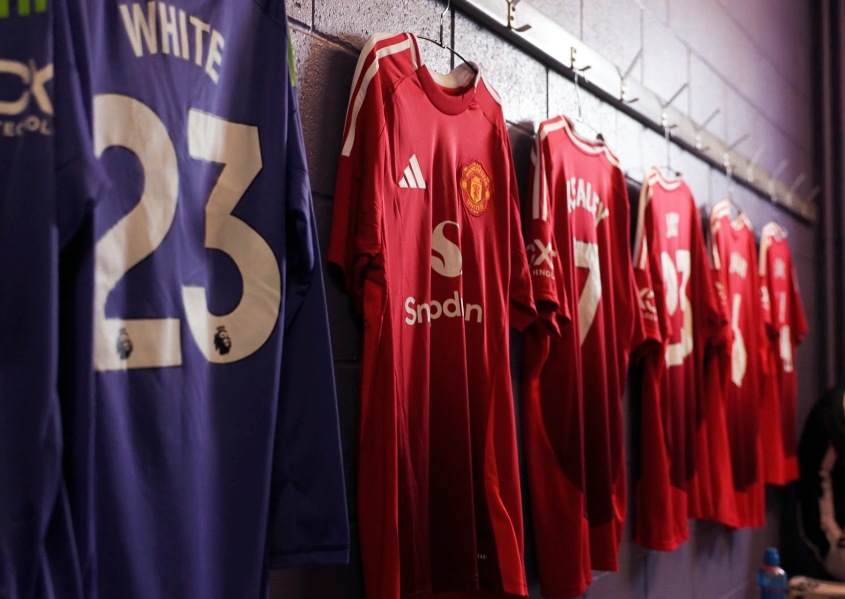 Video screenshot of Manchester Uniter jersey's hanging in the changing room.